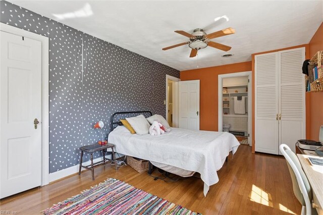 11 Elm Ave, Newport News, VA 23601 - bedroom with wallpapered walls, wood finished floors, ensuite bathroom, and a ceiling fan