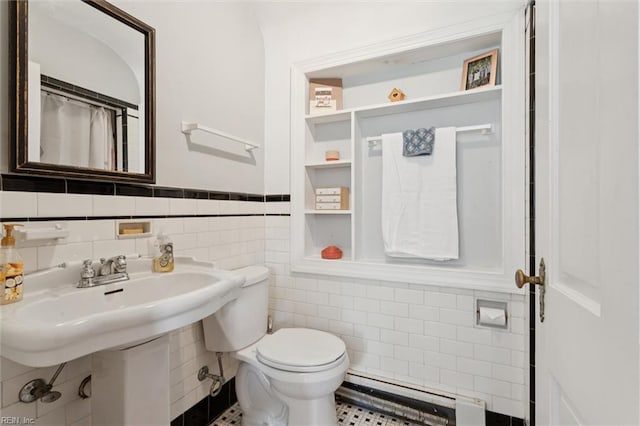11 Elm Ave, Newport News, VA 23601 - bathroom featuring a baseboard radiator, tile walls, a wainscoted wall, and tile patterned flooring