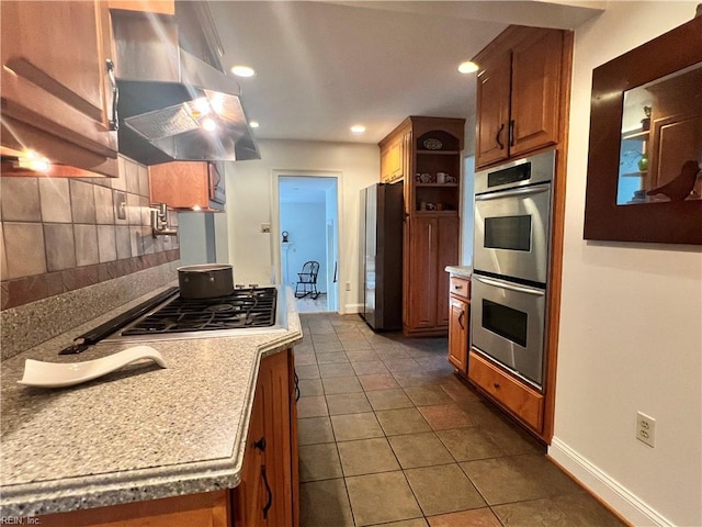 11 Elm Ave, Newport News, VA 23601 - kitchen with appliances with stainless steel finishes, range hood, tasteful backsplash, brown cabinets, and recessed lighting