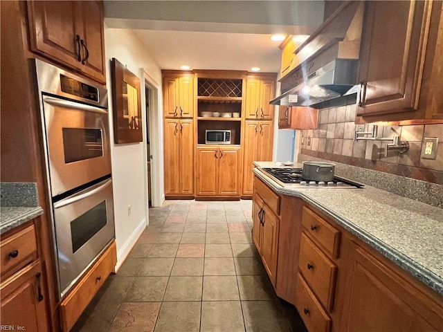 11 Elm Ave, Newport News, VA 23601 - kitchen featuring appliances with stainless steel finishes, wall chimney exhaust hood, decorative backsplash, and brown cabinets