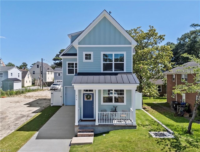 516 26th St, Virginia Beach, VA 23451 - view of front facade with a standing seam roof, board and batten siding, a porch, concrete driveway, and a metal roof