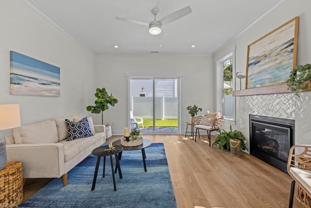 516 26th St, Virginia Beach, VA 23451 - living room featuring wood finished floors, crown molding, a tile fireplace, and a ceiling fan