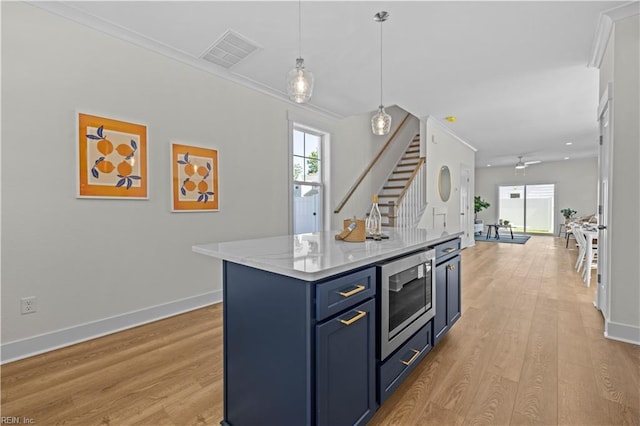516 26th St, Virginia Beach, VA 23451 - kitchen with blue cabinets, healthy amount of natural light, light wood finished floors, ceiling fan, and ornamental molding
