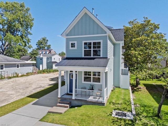 516 26th St, Virginia Beach, VA 23451 - view of front of home with a porch, board and batten siding, a standing seam roof, a front yard, and a metal roof