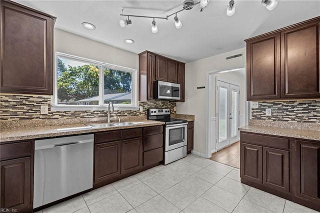 596 Old Post Rd, Virginia Beach, VA 23452 - kitchen featuring appliances with stainless steel finishes, decorative backsplash, dark brown cabinets, light tile patterned floors, and recessed lighting