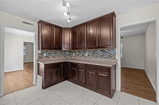 596 Old Post Rd, Virginia Beach, VA 23452 - kitchen featuring light countertops, tasteful backsplash, dark brown cabinetry, and light tile patterned flooring