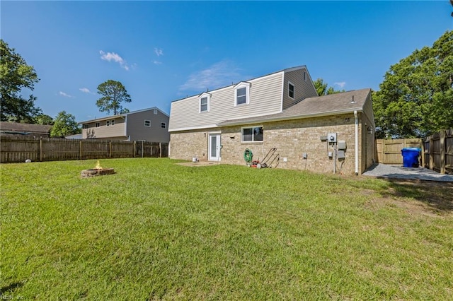 596 Old Post Rd, Virginia Beach, VA 23452 - back of property featuring a fire pit, a fenced backyard, and brick siding