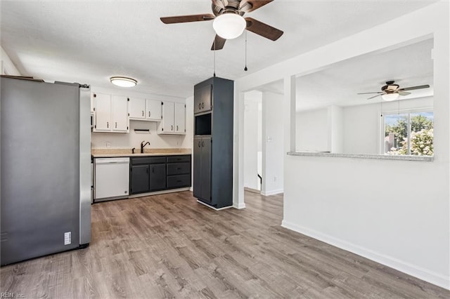 1521 Peabody Dr, Hampton, VA 23666 - kitchen featuring white dishwasher, freestanding refrigerator, a ceiling fan, wood finished floors, and light countertops