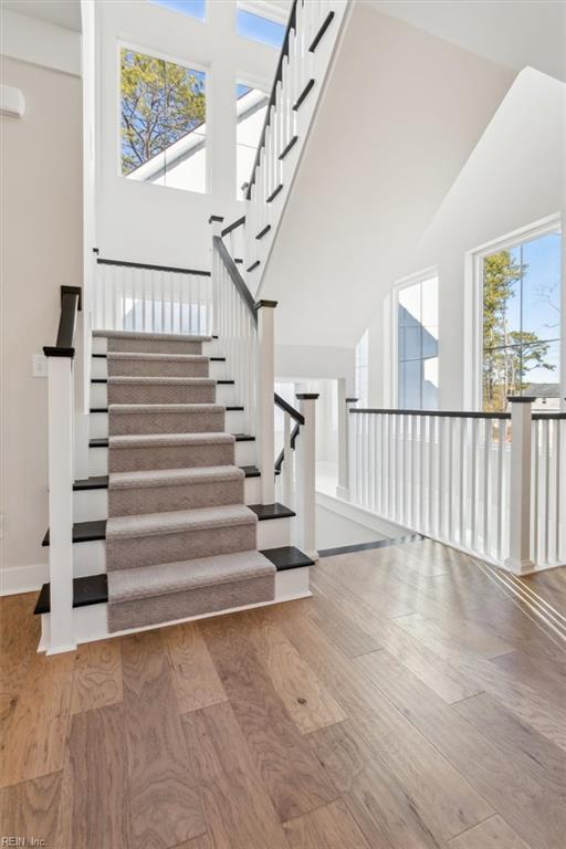 1906 Mccoy Rd, Chesapeake, VA 23323 - stairs featuring a towering ceiling and wood finished floors