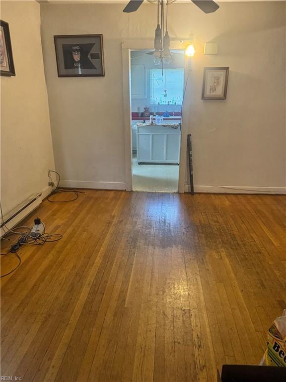 1300 Cass St, Norfolk, VA 23523 - unfurnished dining area featuring a ceiling fan, wood-type flooring, and a baseboard heating unit