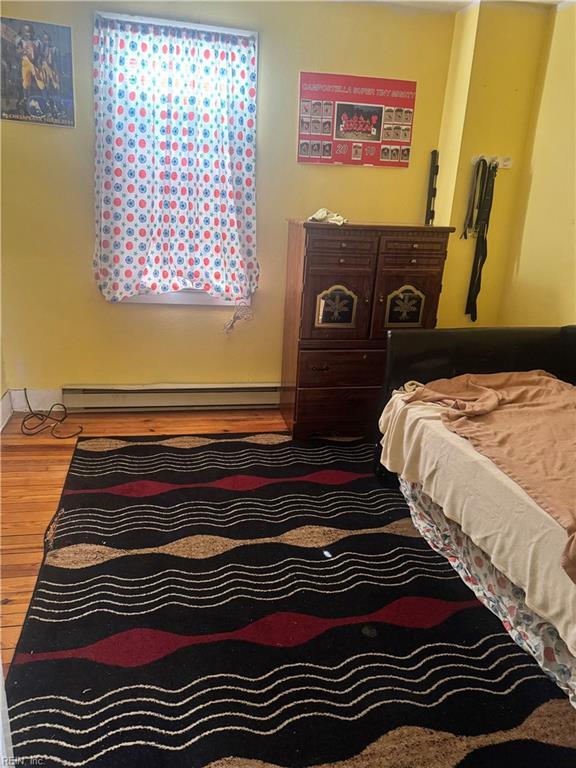 1300 Cass St, Norfolk, VA 23523 - bedroom with a baseboard radiator and wood finished floors