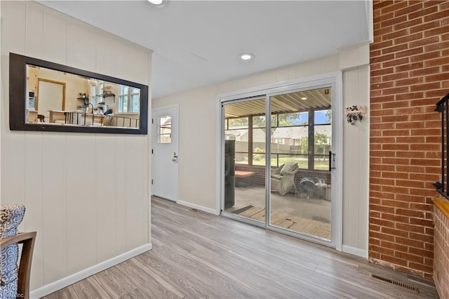 2218 Haywood Ave, Chesapeake, VA 23324 - doorway with light wood-style flooring, recessed lighting, and brick wall