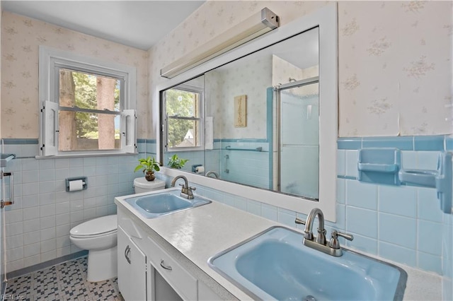 2218 Haywood Ave, Chesapeake, VA 23324 - full bath featuring tile walls, wallpapered walls, a shower stall, a wainscoted wall, and double vanity