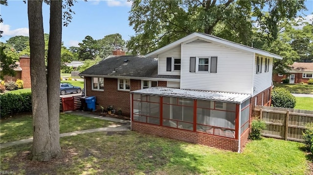 2218 Haywood Ave, Chesapeake, VA 23324 - back of property featuring a sunroom, brick siding, and a chimney