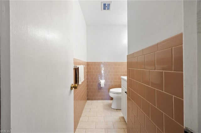 16 Diggs Dr, Hampton, VA 23666 - half bathroom with tile walls, tile patterned floors, vanity, and wainscoting