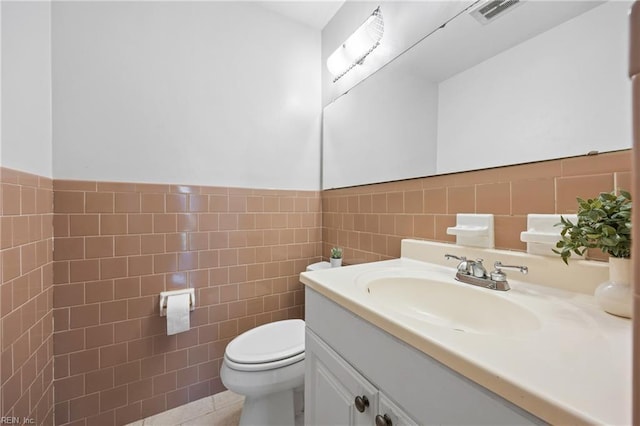16 Diggs Dr, Hampton, VA 23666 - half bathroom with tile walls, vanity, a wainscoted wall, and tile patterned flooring