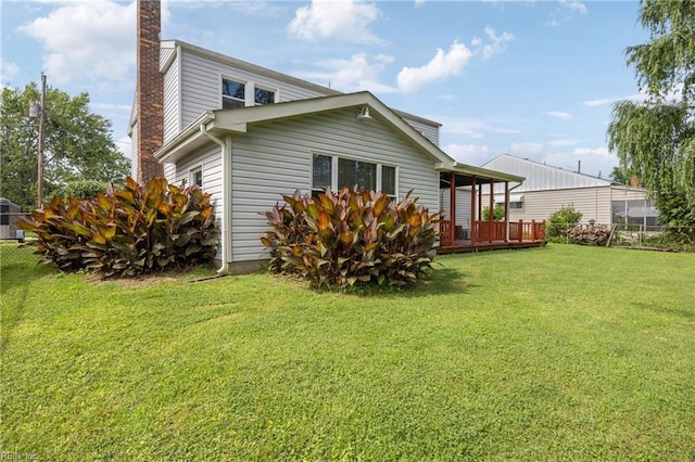 16 Diggs Dr, Hampton, VA 23666 - view of home's exterior featuring a chimney, a lawn, and a wooden deck