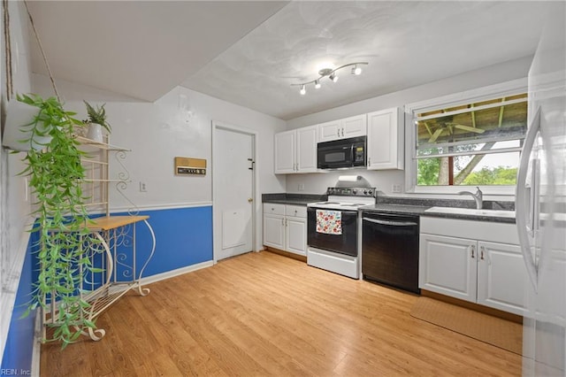 16 Diggs Dr, Hampton, VA 23666 - kitchen with black appliances, dark countertops, light wood-style floors, and white cabinetry