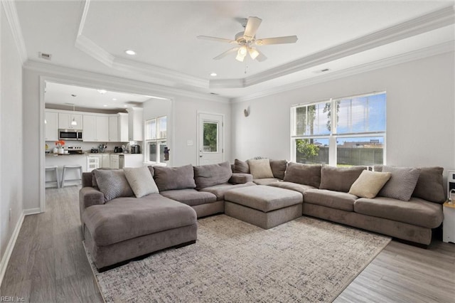 208 Parkdale Ave, Hampton, VA 23669 - living room featuring light wood-style floors, a raised ceiling, a ceiling fan, ornamental molding, and recessed lighting