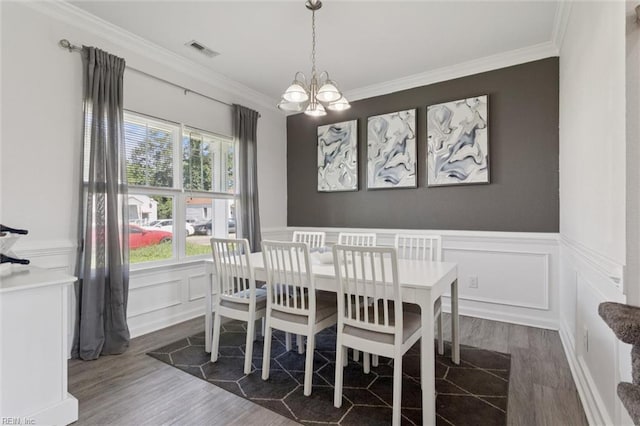 208 Parkdale Ave, Hampton, VA 23669 - dining space with a chandelier, ornamental molding, a decorative wall, dark wood finished floors, and a wainscoted wall