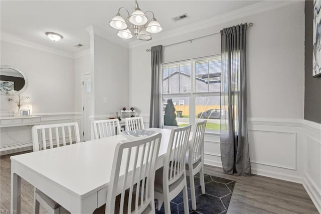 208 Parkdale Ave, Hampton, VA 23669 - dining area with ornamental molding, a chandelier, wood finished floors, wainscoting, and a decorative wall