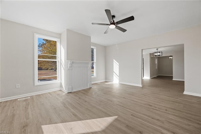 10 Church St, Windsor, VA 23487 - unfurnished living room featuring light wood-type flooring, a chandelier, and ceiling fan