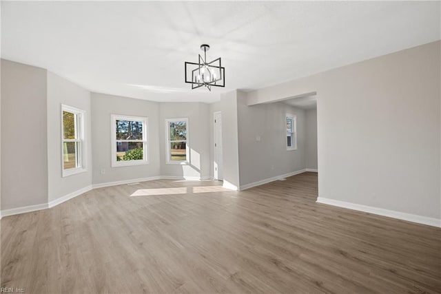 10 Church St, Windsor, VA 23487 - unfurnished living room with a chandelier and light wood-style flooring