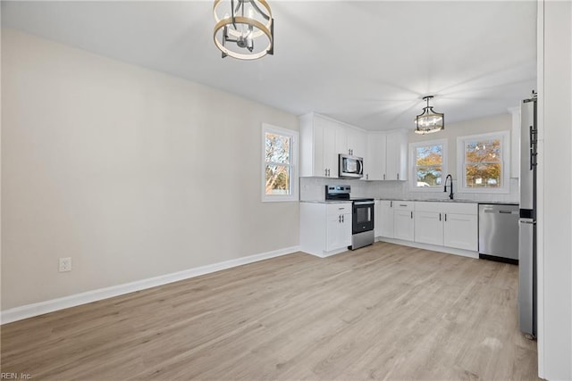 10 Church St, Windsor, VA 23487 - kitchen featuring appliances with stainless steel finishes, a chandelier, plenty of natural light, and light wood-type flooring