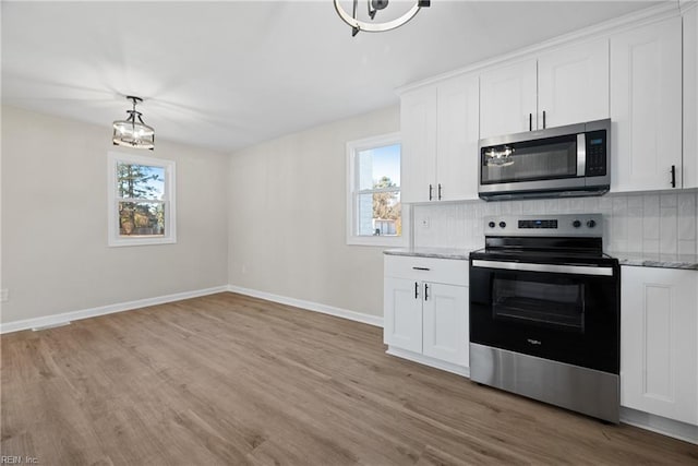 10 Church St, Windsor, VA 23487 - kitchen featuring stainless steel appliances, backsplash, and light wood finished floors