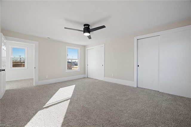 10 Church St, Windsor, VA 23487 - unfurnished bedroom featuring multiple closets, carpet flooring, and a ceiling fan