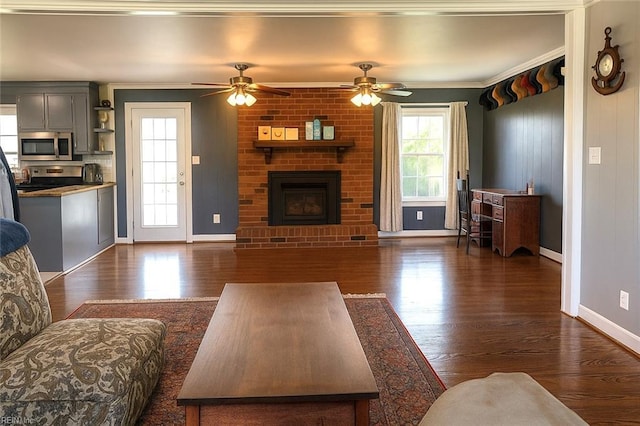 4225 Terry Dr, Chesapeake, VA 23321 - living room with dark wood-type flooring, a brick fireplace, crown molding, and a ceiling fan