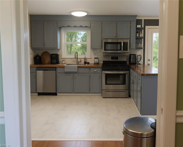 4225 Terry Dr, Chesapeake, VA 23321 - kitchen with appliances with stainless steel finishes, gray cabinetry, open shelves, and wood counters