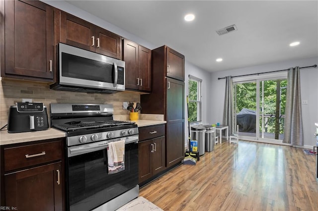 4041 Hargrove Lndg, Suffolk, VA 23435 - kitchen featuring stainless steel appliances, light countertops, backsplash, light wood-style flooring, and dark brown cabinetry