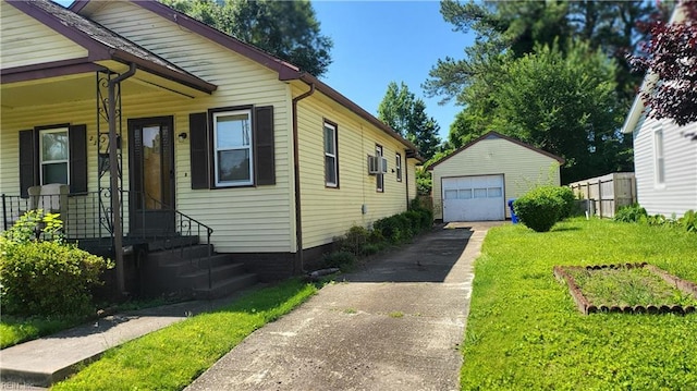 2209 Saint Denis Ave, Norfolk, VA 23509 - view of side of property featuring asphalt driveway, an outdoor structure, a garage, and a lawn