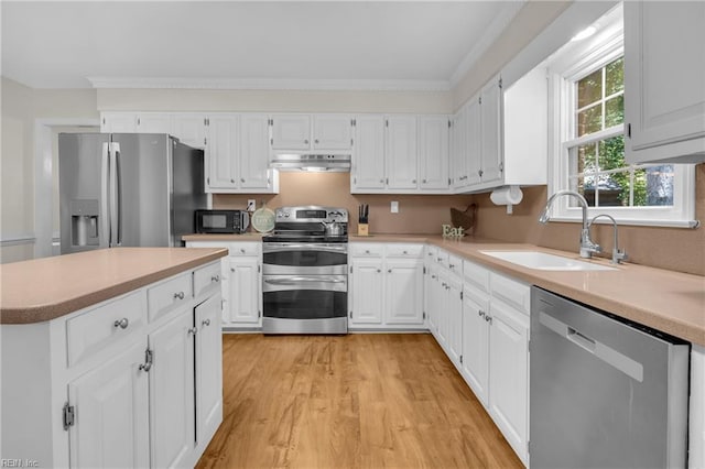 605 Hollygate Ln, Chesapeake, VA 23322 - kitchen featuring stainless steel appliances, under cabinet range hood, white cabinets, light countertops, and light wood-type flooring