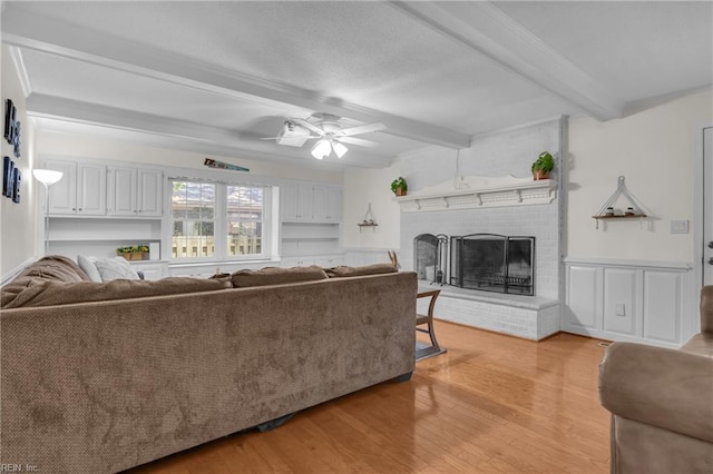 605 Hollygate Ln, Chesapeake, VA 23322 - living area featuring beam ceiling, light wood-type flooring, a brick fireplace, and ceiling fan