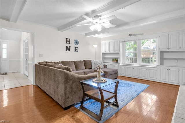 605 Hollygate Ln, Chesapeake, VA 23322 - living room featuring beam ceiling, plenty of natural light, light wood-style floors, a ceiling fan, and a textured ceiling