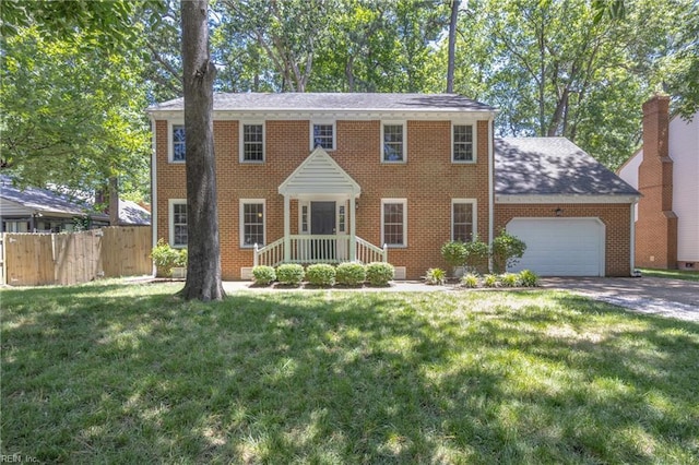 605 Hollygate Ln, Chesapeake, VA 23322 - colonial-style house featuring an attached garage, brick siding, and concrete driveway