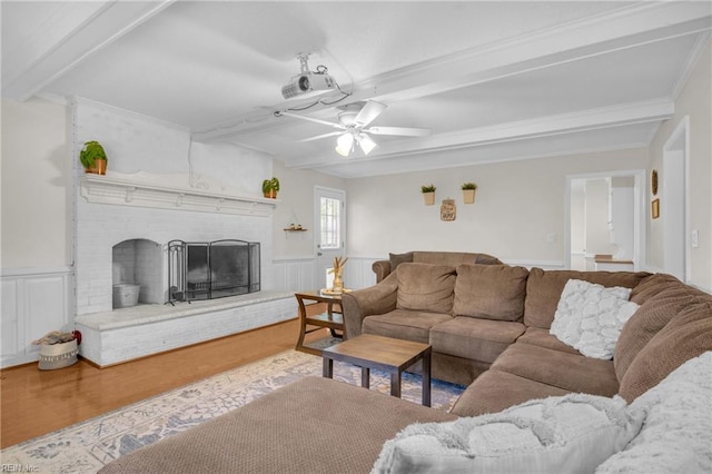 605 Hollygate Ln, Chesapeake, VA 23322 - living room with beamed ceiling, ceiling fan, wood finished floors, a brick fireplace, and wainscoting