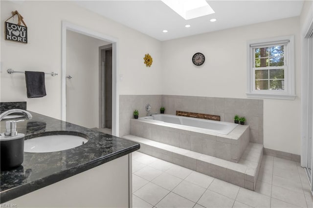 605 Hollygate Ln, Chesapeake, VA 23322 - bathroom featuring a skylight, vanity, a garden tub, tile patterned flooring, and recessed lighting