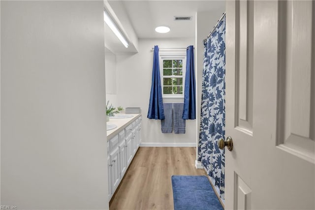 605 Hollygate Ln, Chesapeake, VA 23322 - bathroom with double vanity, wood finished floors, and curtained shower