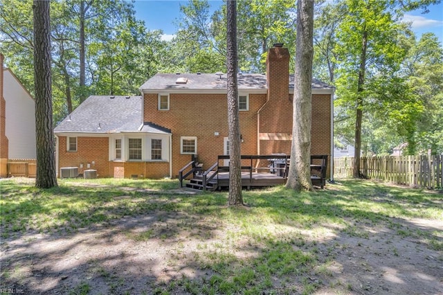 605 Hollygate Ln, Chesapeake, VA 23322 - back of property featuring a fenced backyard, a chimney, a deck, and brick siding