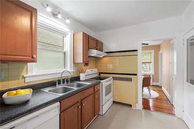440 Maryland Ave, Norfolk, VA 23508 - kitchen with white appliances, under cabinet range hood, dark countertops, and tasteful backsplash