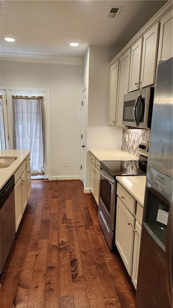 217 Wineberry Way, Yorktown, VA 23692 - kitchen featuring stainless steel appliances, dark wood-style floors, recessed lighting, light countertops, and crown molding