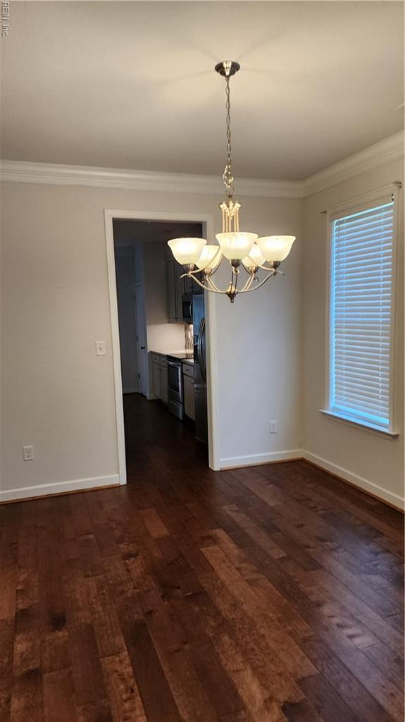 217 Wineberry Way, Yorktown, VA 23692 - unfurnished room featuring a chandelier, dark wood-style flooring, and crown molding