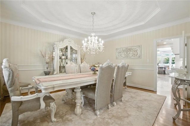 4028 Timber Ridge Dr, Virginia Beach, VA 23455 - dining room featuring a chandelier, wood finished floors, ornamental molding, a raised ceiling, and wallpapered walls