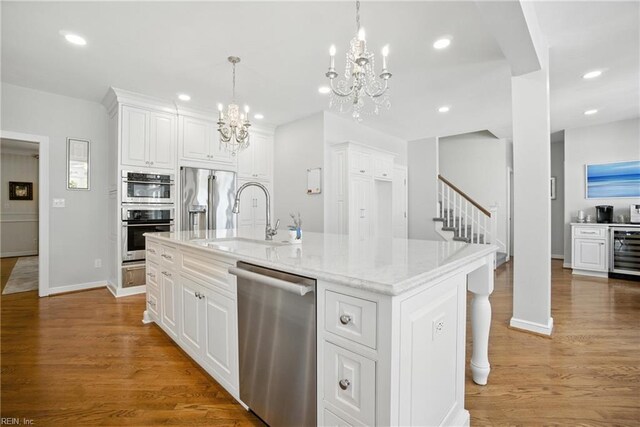 4028 Timber Ridge Dr, Virginia Beach, VA 23455 - kitchen featuring stainless steel appliances, a chandelier, beverage cooler, white cabinetry, and light stone countertops