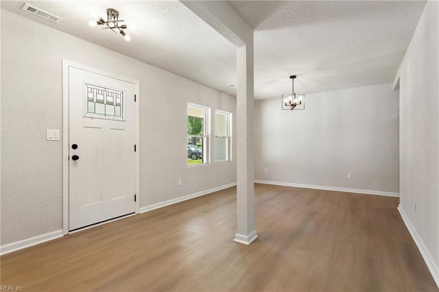 4809 Orchard Ln, Virginia Beach, VA 23464 - foyer with a chandelier, wood finished floors, and a textured ceiling