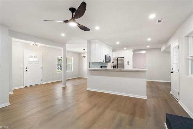 4809 Orchard Ln, Virginia Beach, VA 23464 - kitchen with stainless steel appliances, a ceiling fan, white cabinetry, wood finished floors, and recessed lighting