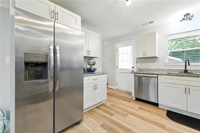 78 Calvary Ter, Hampton, VA 23666 - kitchen featuring appliances with stainless steel finishes, plenty of natural light, white cabinets, and light stone counters